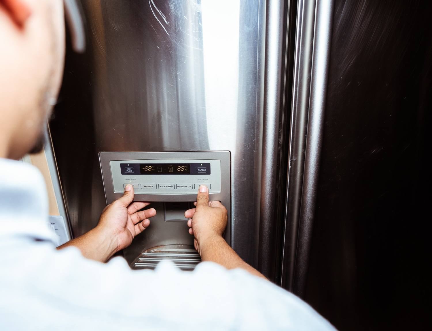 Doctor Maintenance technician repairing a home appliance during a weekday repair visit in Frederick, Frederick County, MD