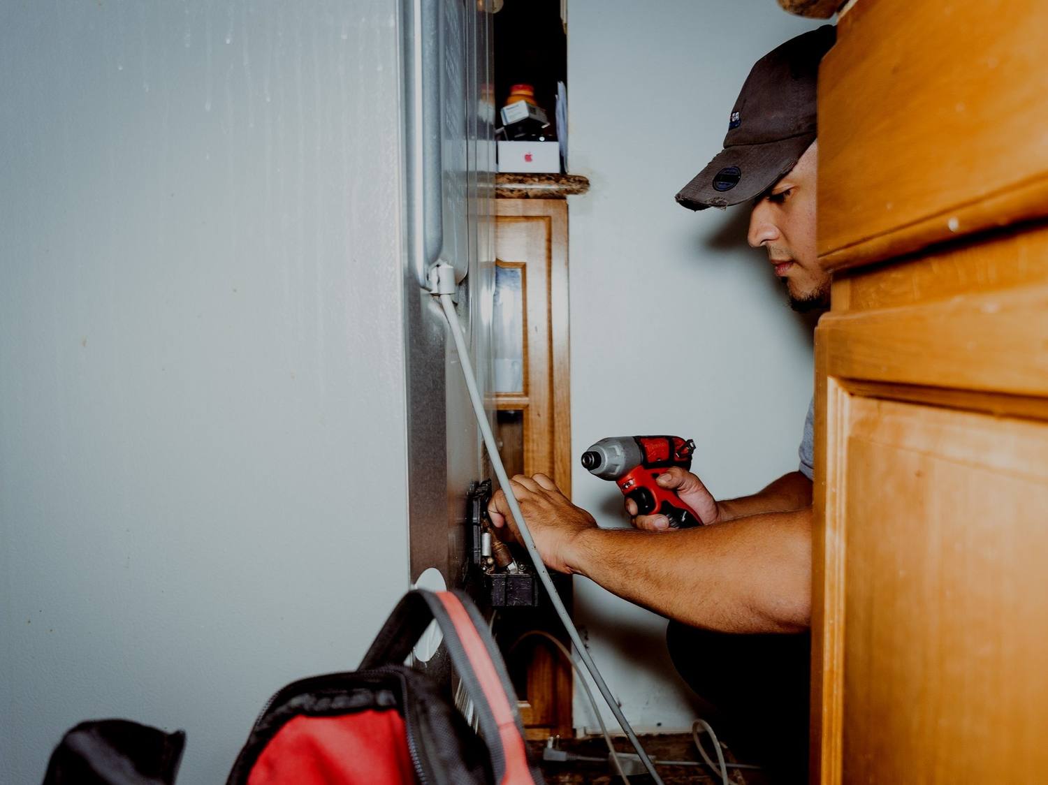 Doctor Maintenance technician repairing a home appliance during a scheduled weekday visit in Annapolis, Anne Arundel County, MD