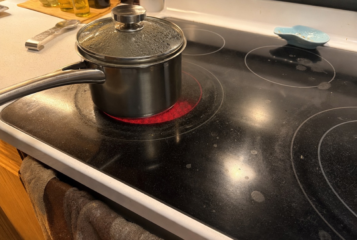 A glass cooktop element glowing under a pot during a Baltimore, MD cooktop repair by Doctor Maintenance
