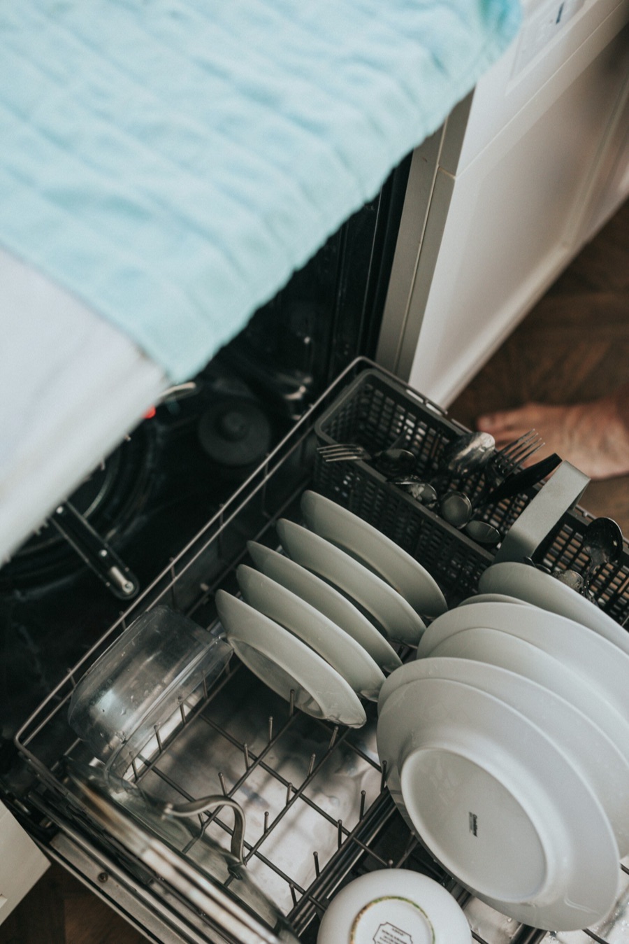 A loaded dishwasher in a Baltimore, MD kitchen, one of the Whirlpool family appliances Doctor Maintenance diagnoses by error code and by meter