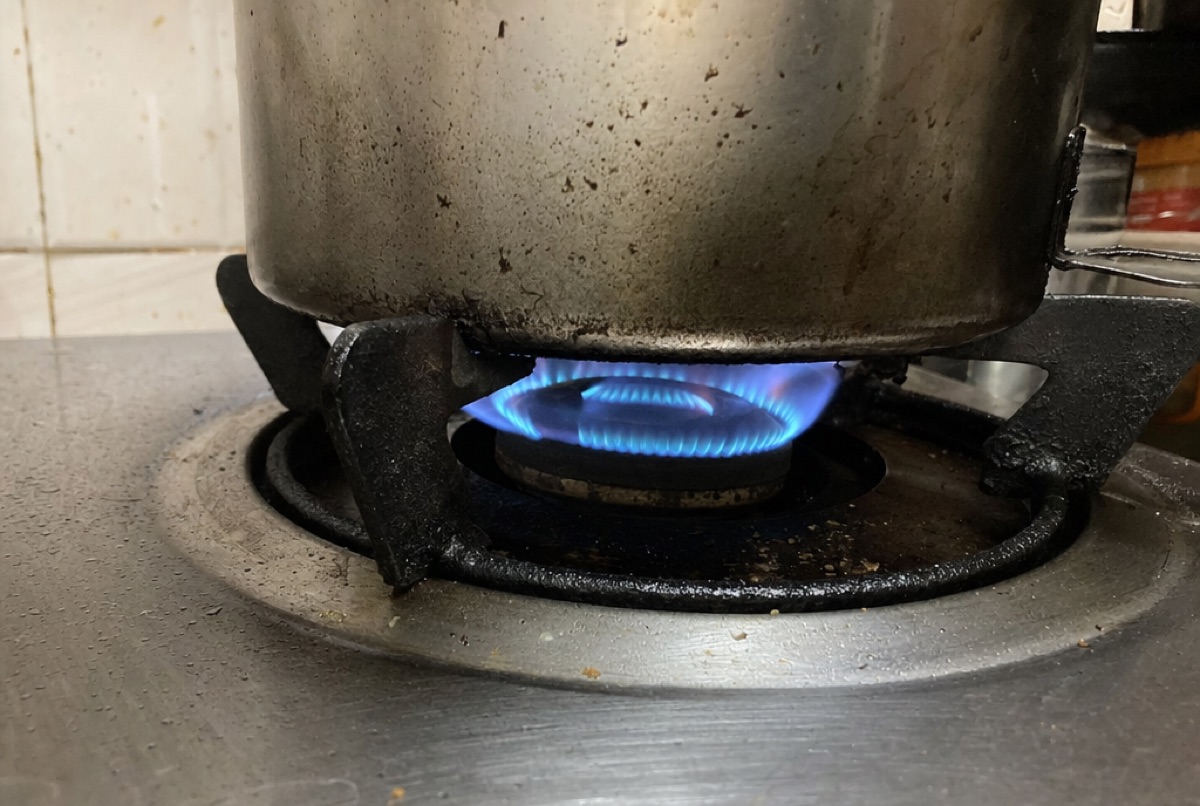 A gas burner lit under a pot in a Baltimore, MD kitchen, the kind of Whirlpool range igniter and element repair Doctor Maintenance diagnoses on site