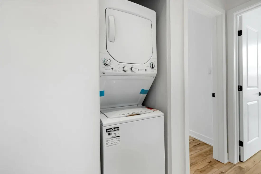 A stacked washer and dryer laundry center in a narrow Baltimore, MD hallway closet, a tight install Doctor Maintenance services on weekdays